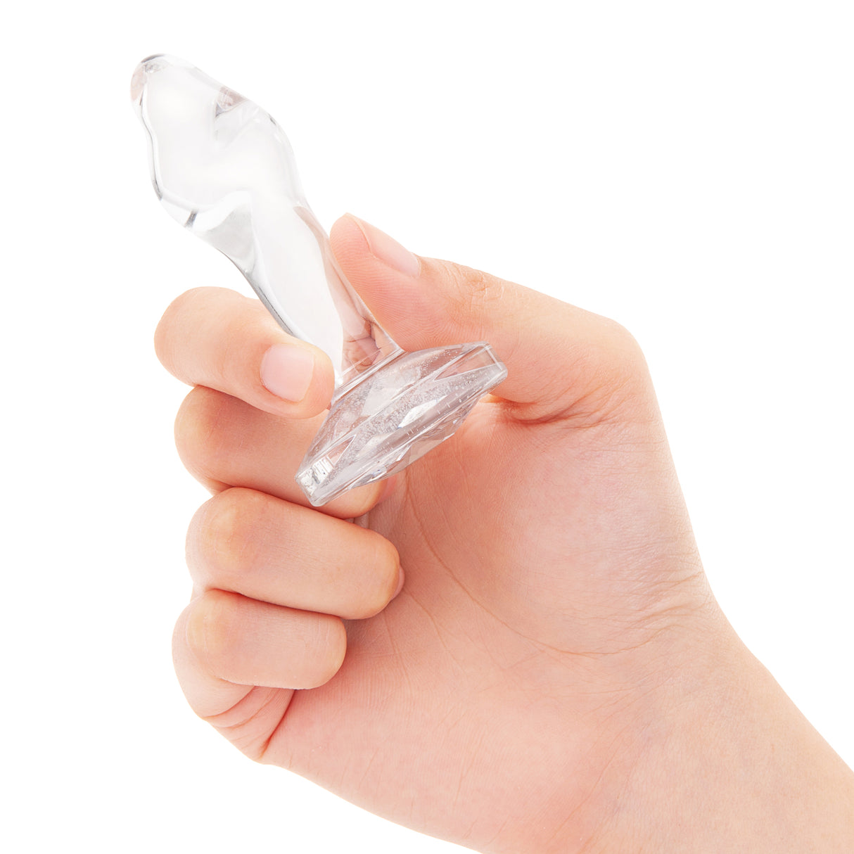 3" Sweet Twist Butt Plug - Small In-Hand/Scale: Clear glass twist plug held in hand to demonstrate the contoured grip and overall size.
