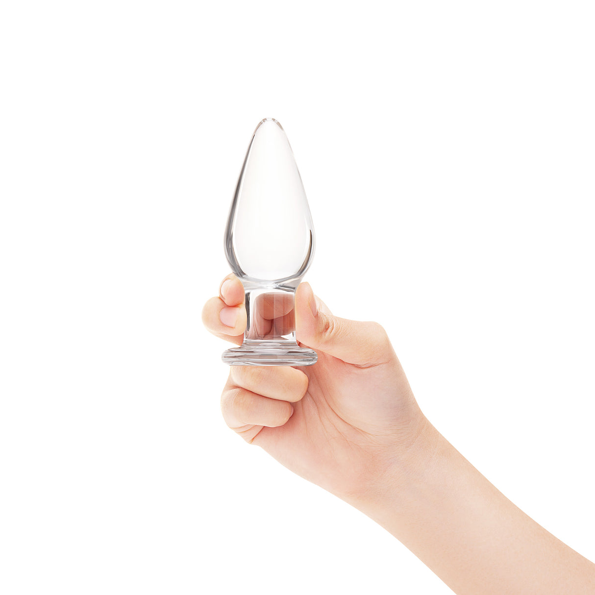 A hand holding the clear glass plug to show its compact size, lightweight feel, and controlled grip.