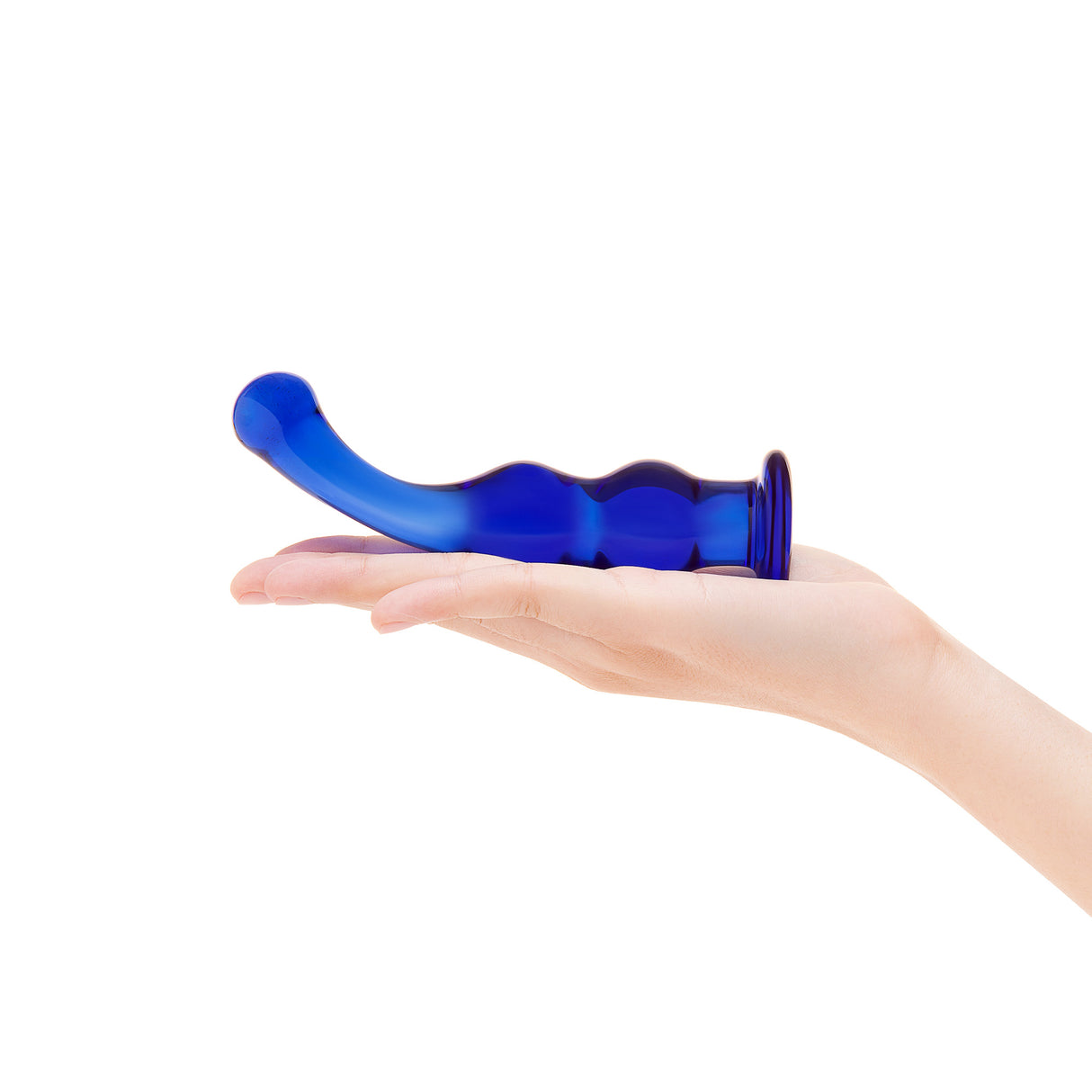 Blue glass dildo in a hand on a white background