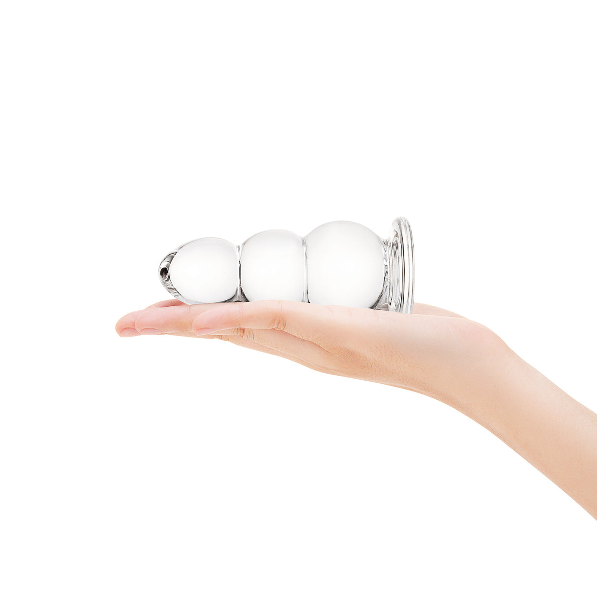 A hand holding the plug to show its compact overall size and the distinct three-bulb shape.