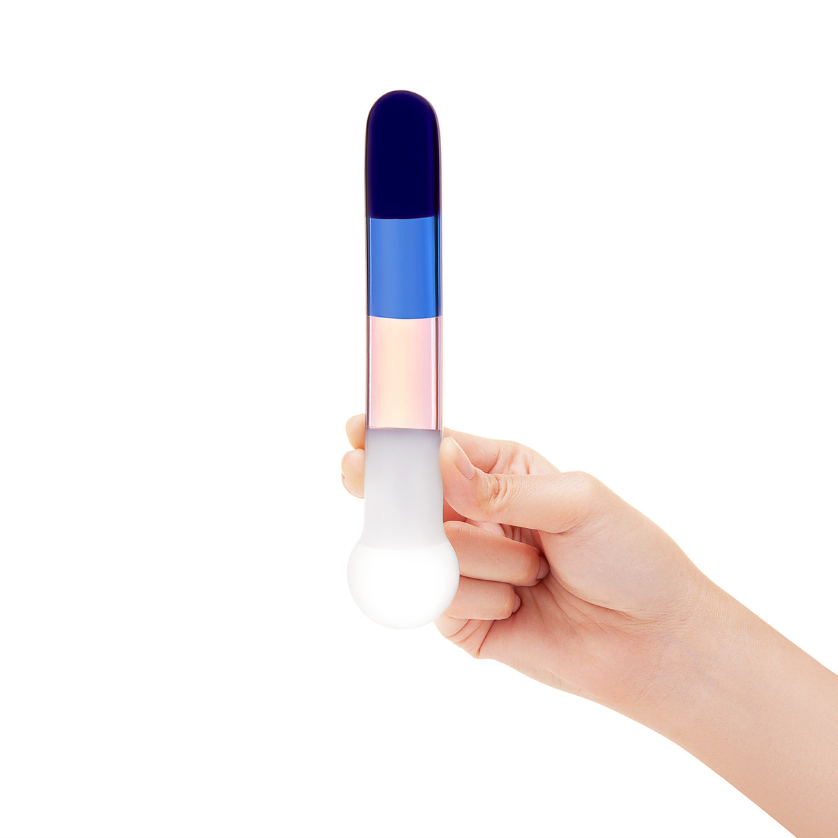 A hand holding the wand by the bulbous base to show the length of the shaft and the scale of the color blocks.