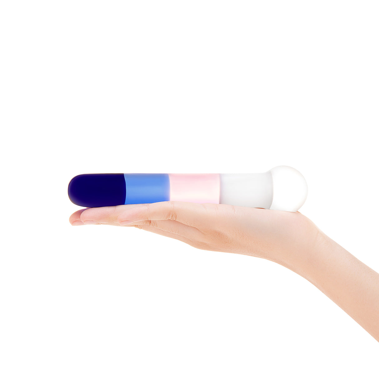 A hand holding the wand to show the length of the shaft and the scale of the color blocks.