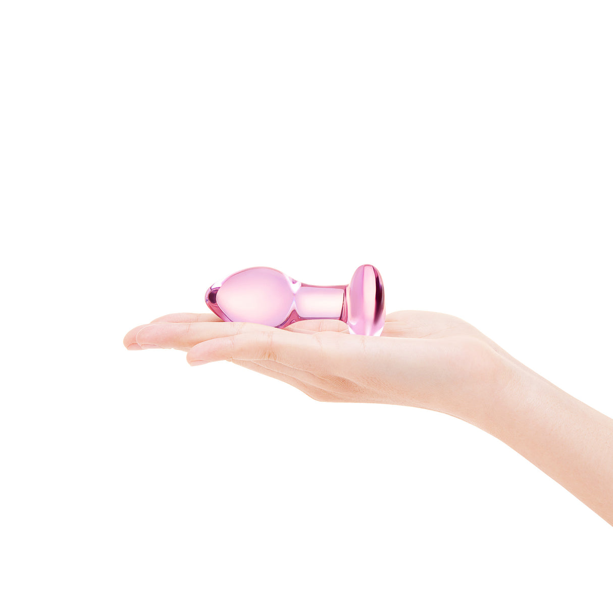 A hand holding the small plug to show its petite, beginner-friendly size and lightweight design.