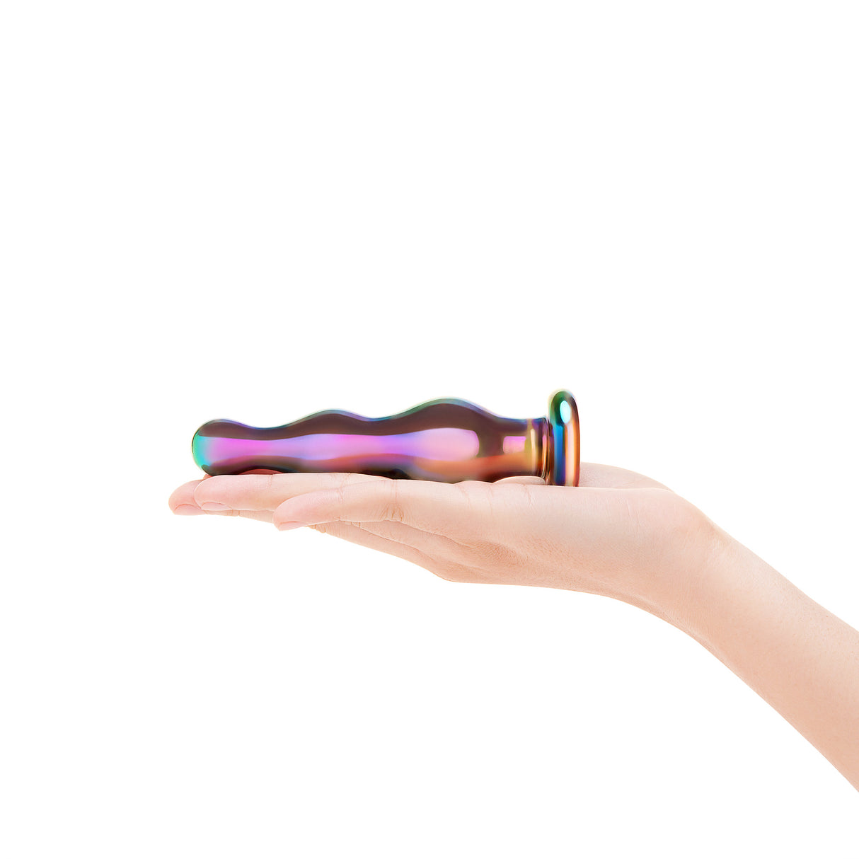 Hand holding a colorful anal glass plug against a white background