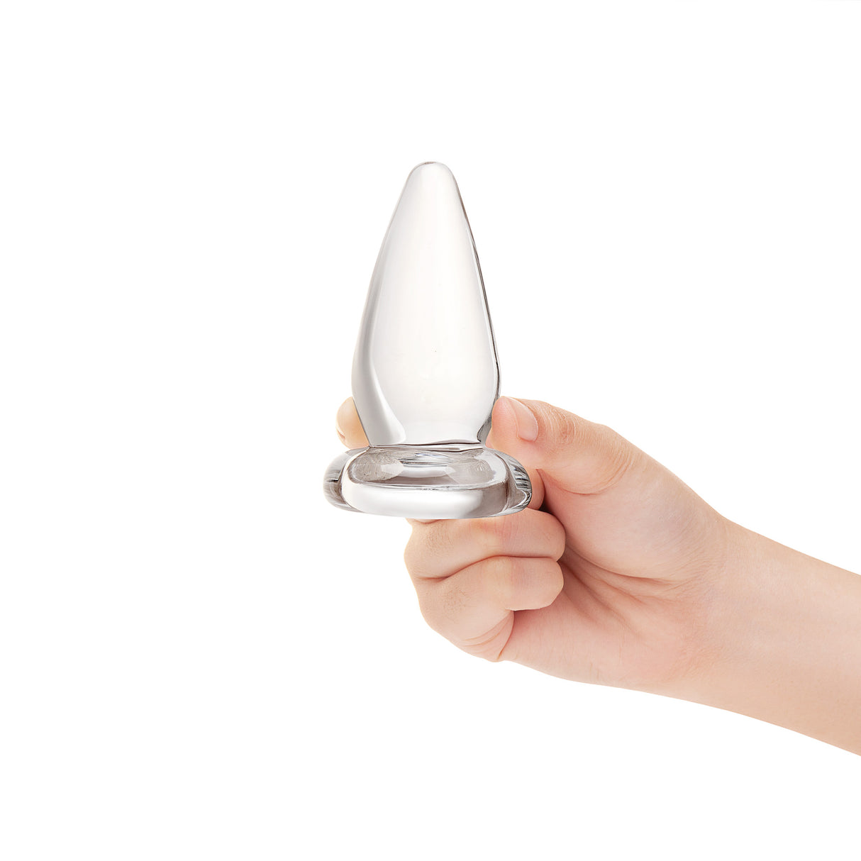 Hand holding a Clear glass cone-shaped anal plug against a white background