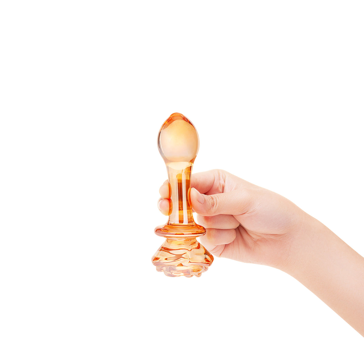 A hand gently holding the 5.25-inch plug to demonstrate the scale and the elegant golden color against skin.