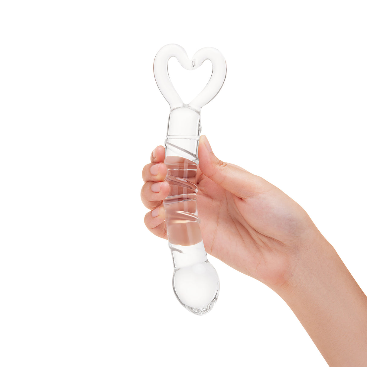 Hand holding a Spiraled Ridge Glass Dildo with heart-shaped base on a white background