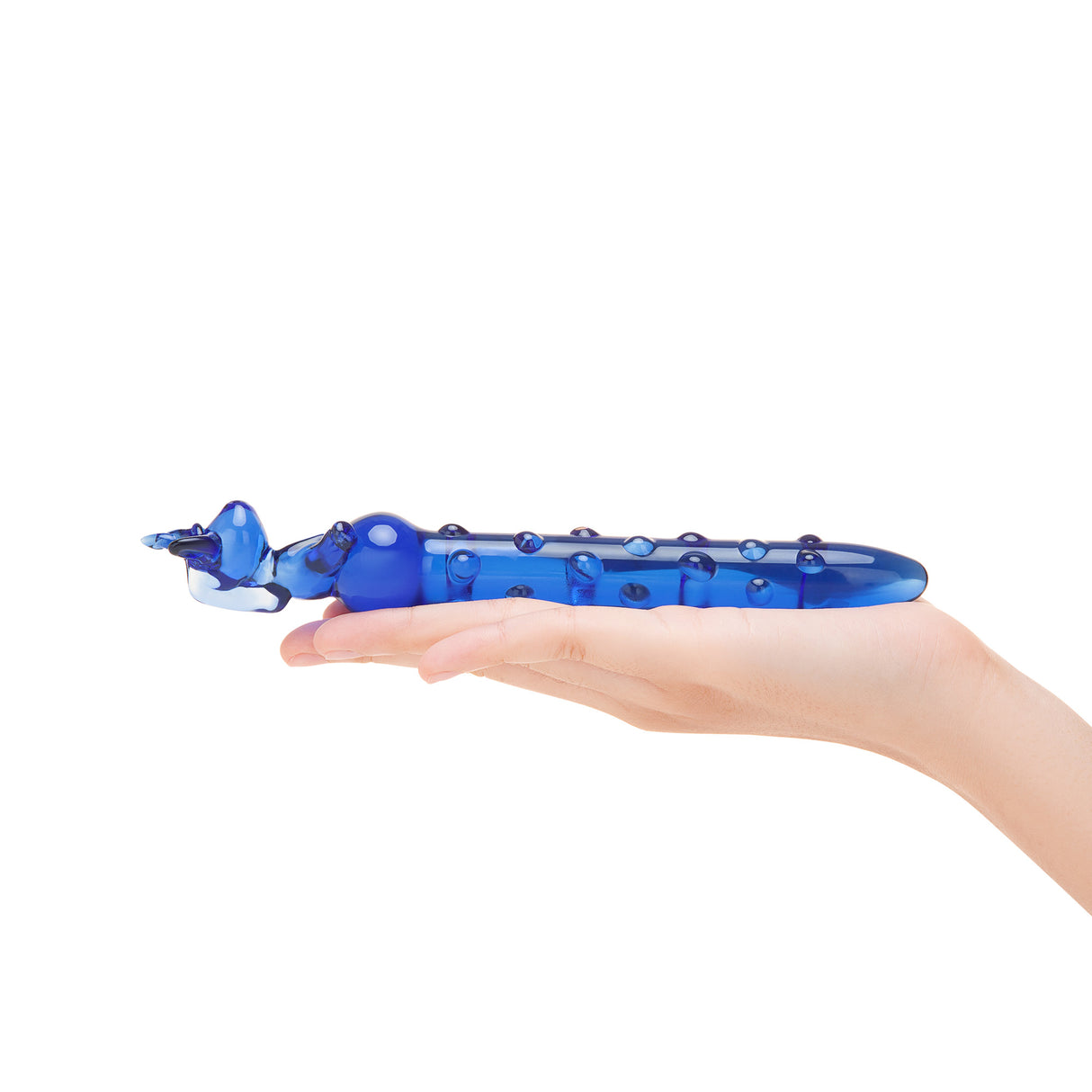 Blue Nubbed Glass Dildo with unicorn shaped held in a hand on a white background