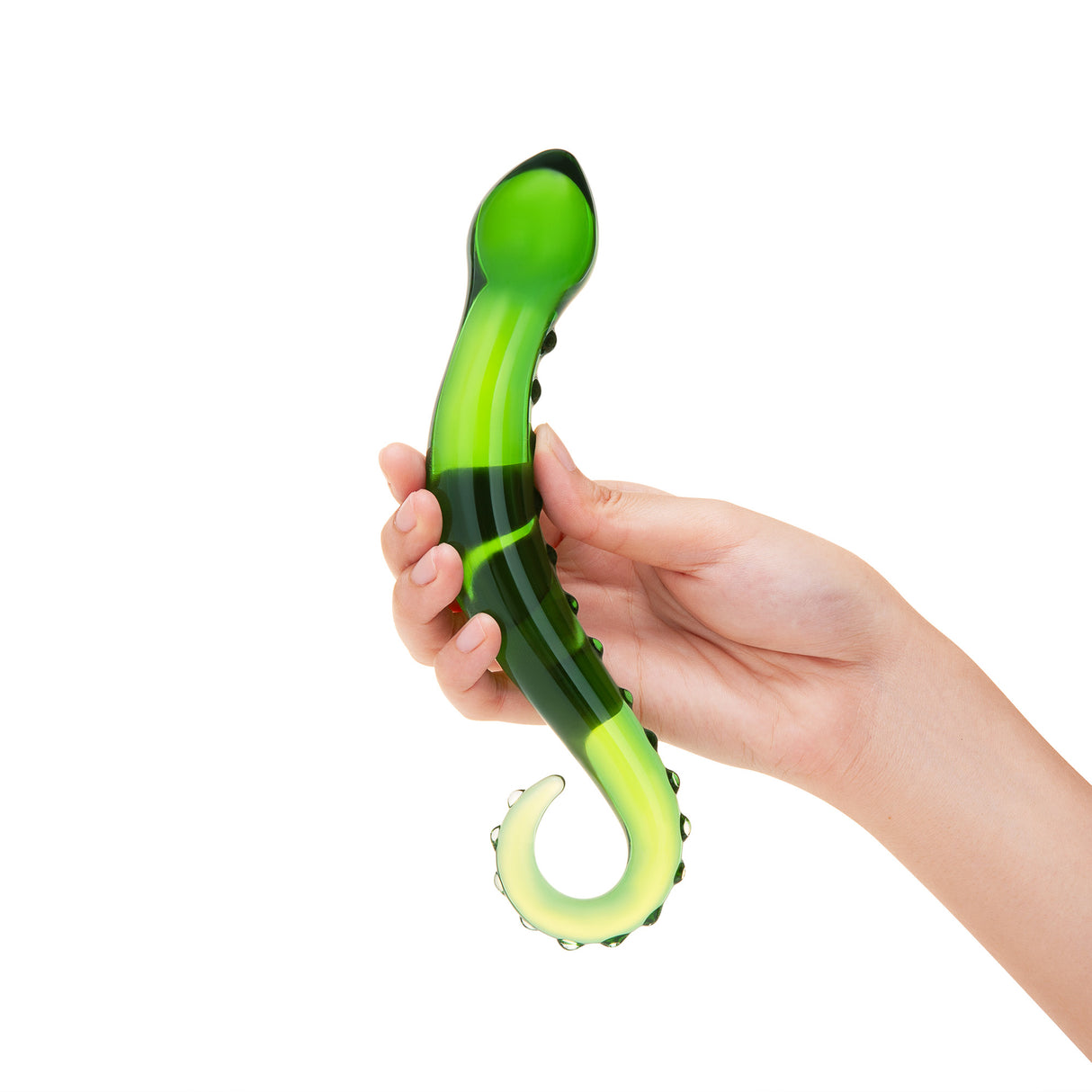 Hand holding a Green Nubbed Glass Dildo with a ring-shaped handle and nubbed shaft on a white background