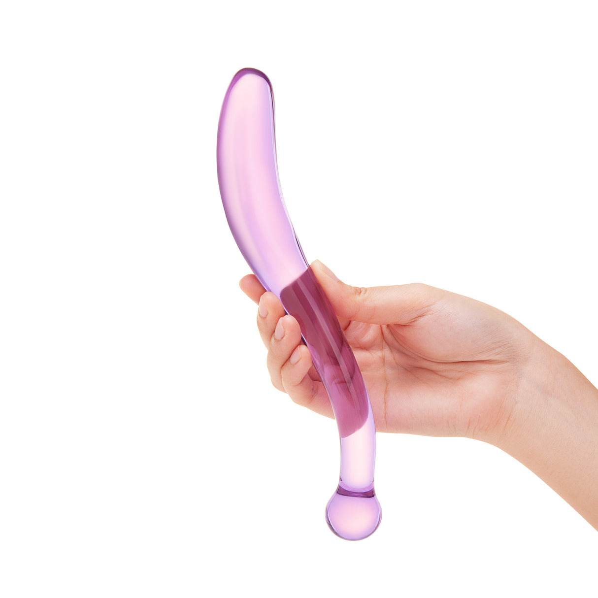 Hand holding a Purple and pink elongated S-shape glass dildo with a smooth shaft and round base against a white background