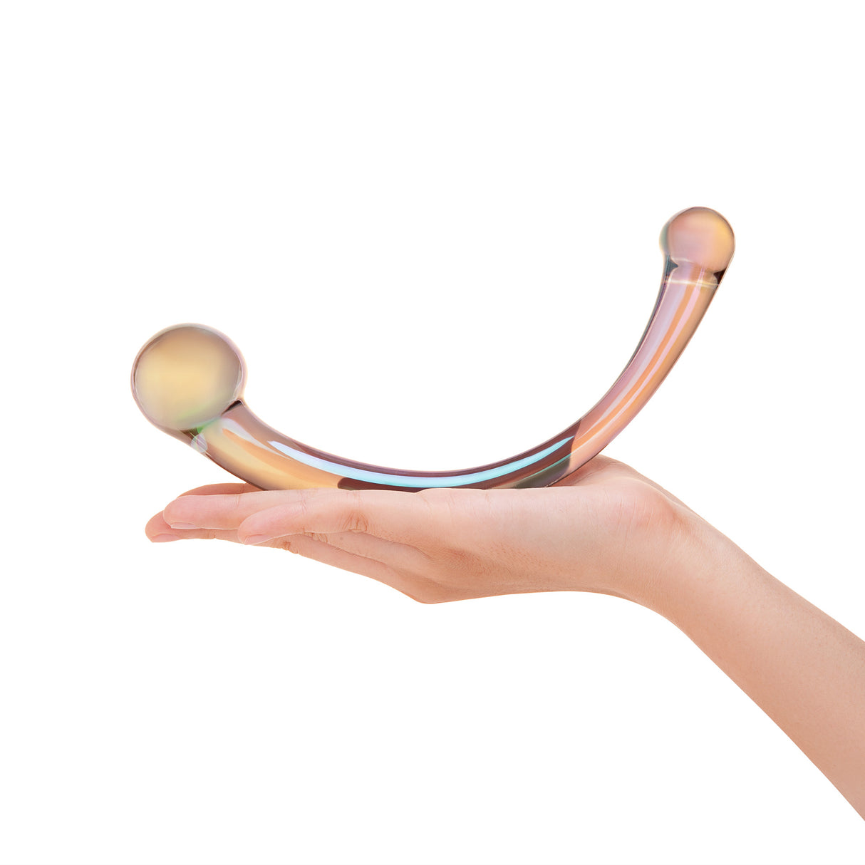 Hand holding a rMulticolored c-shaped glass dildo against a white background