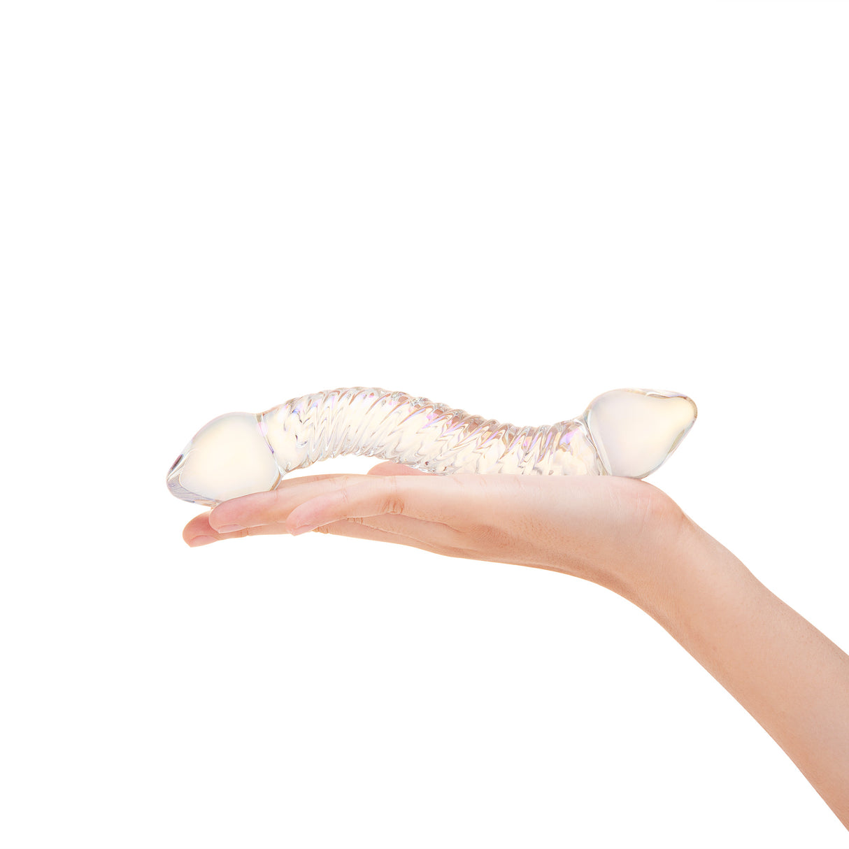 A hand holding the toy at the center to show grip, thickness, and overall length in a natural pose.