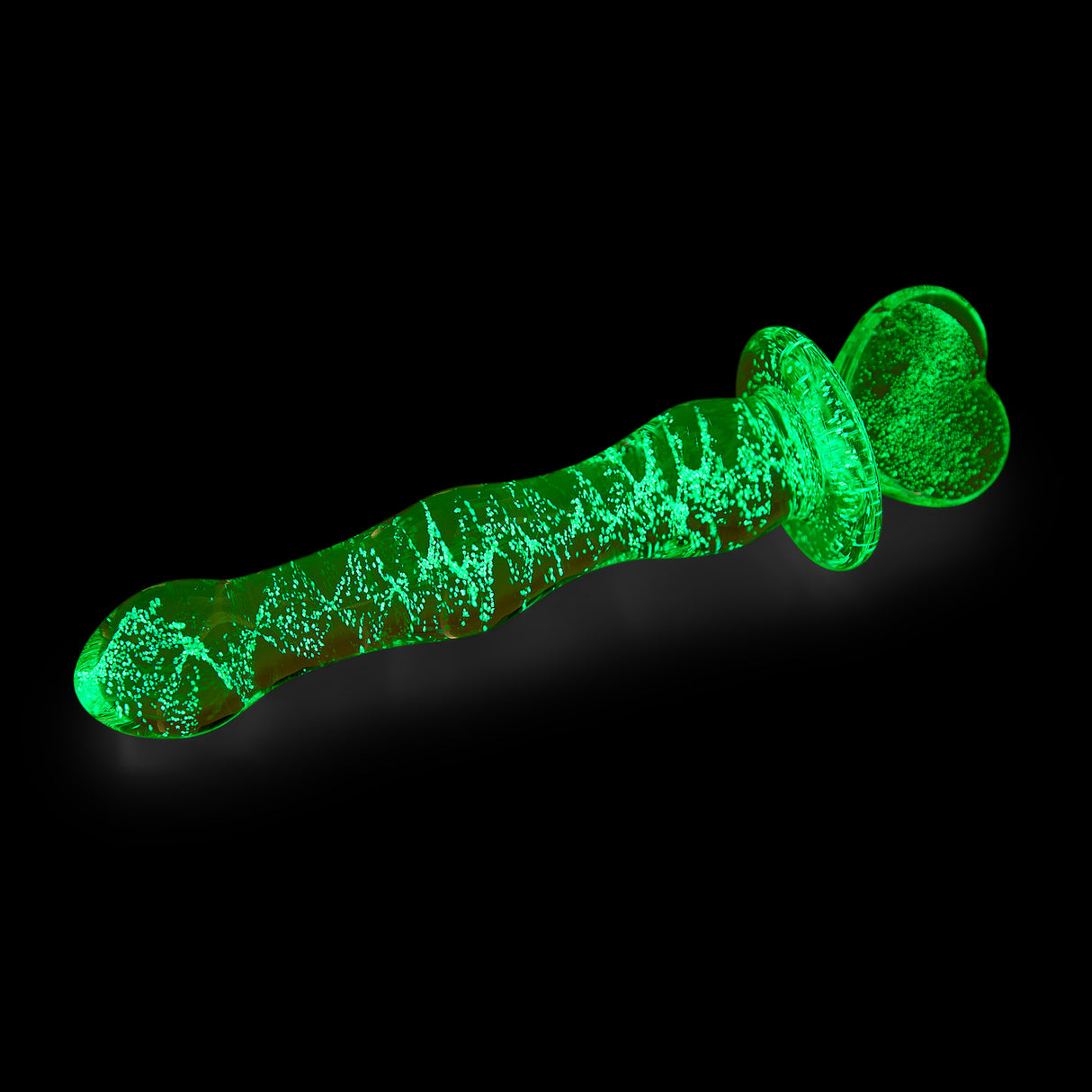 Glowing Glow-in-the-Dark Glass with a heart-shaped base on a black background