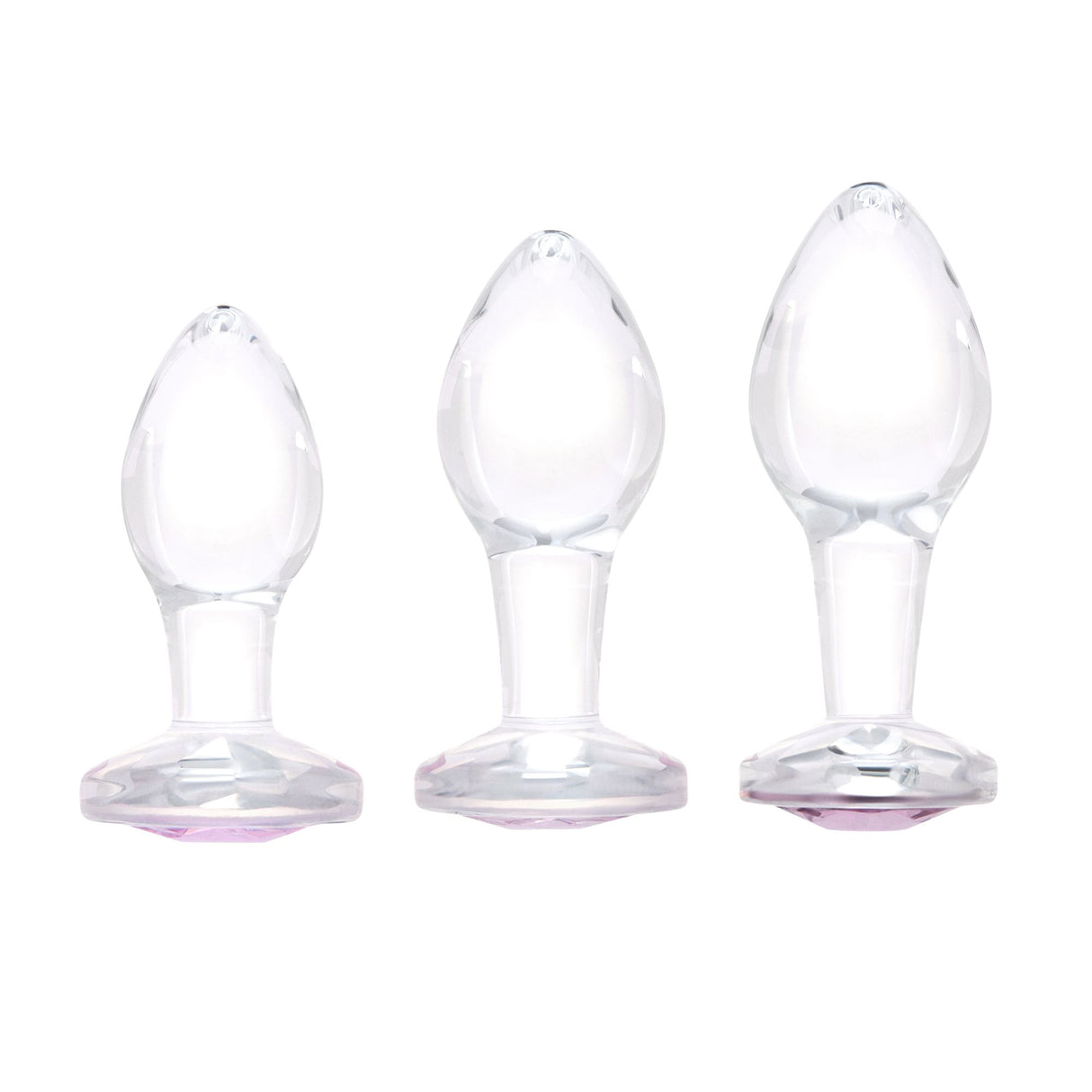 Scale Reference: Three clear glass pink-gem plugs grouped together to illustrate Small, Medium, and Large sizes.