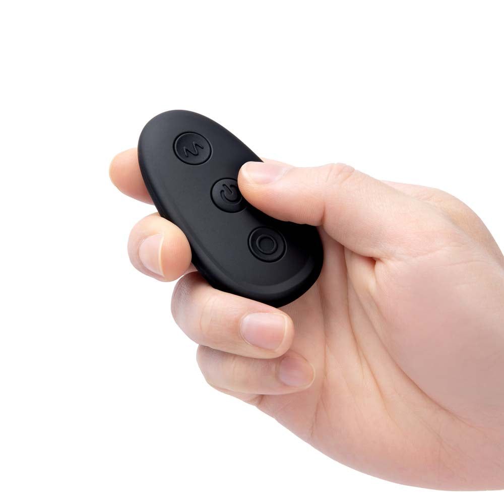 Model holding the remote control of the Blue Line Impaler - Deep Drilling Remote Controlled Butt Plug