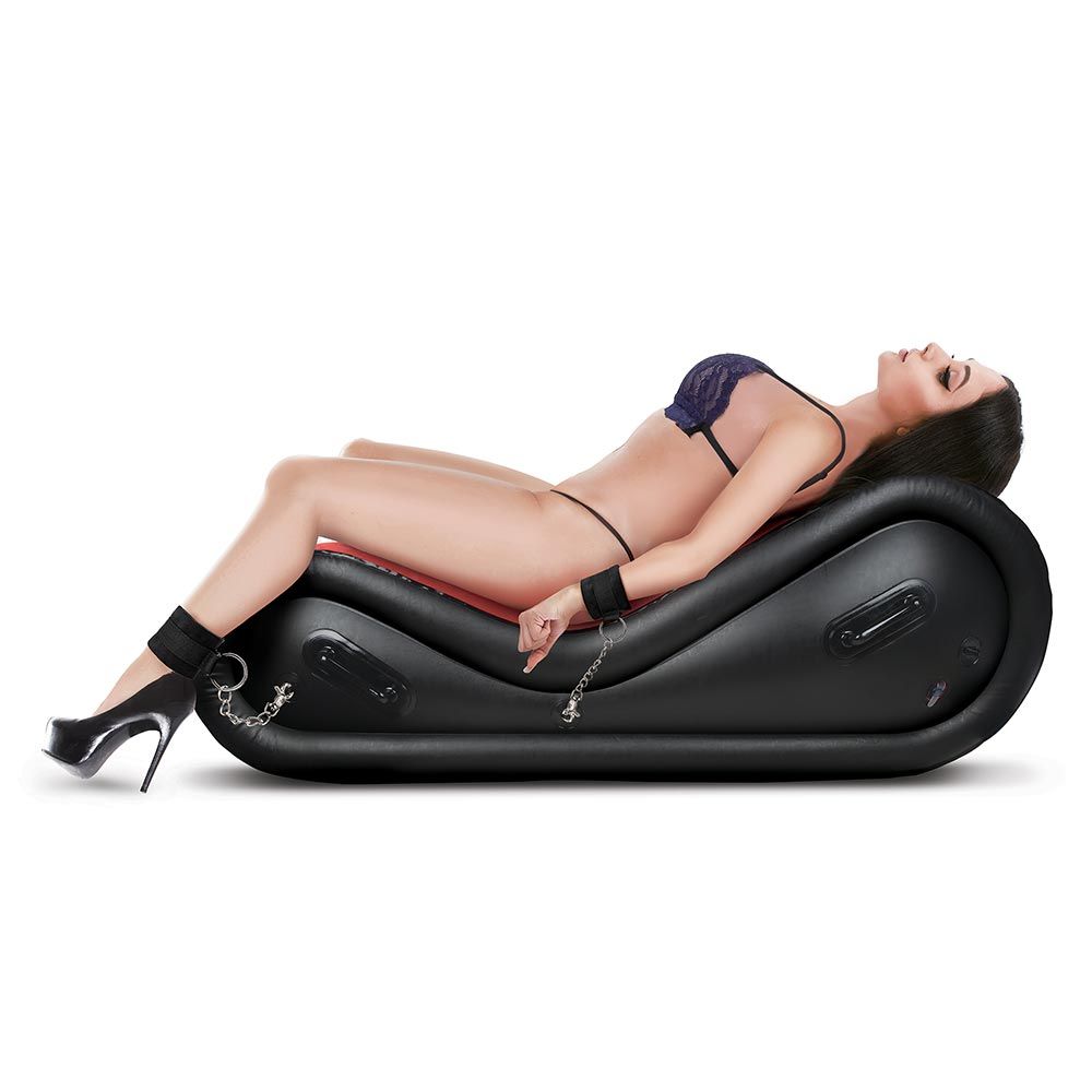 Model lying down with wrists and ankles cuffed to the inflatable sex sofa with the Lux Fetish 6-Piece Inflatable BDSM Sex Sofa Set