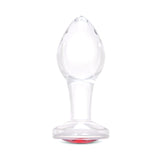 3.35" Cherry Sparkle Butt Plug - Medium Clear borosilicate glass butt plug shown upright featuring a teardrop shape and ruby red gem base.