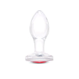 3" Cherry Sparkle Butt Plug - Small Clear borosilicate glass butt plug shown upright featuring a teardrop shape and ruby red gem base.