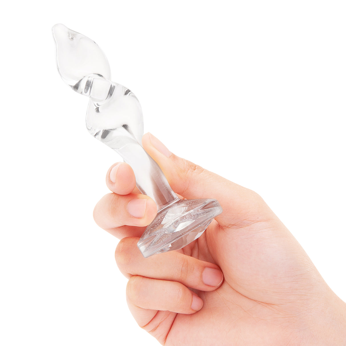 4.5" Twist and Tush Butt Plug - Large   In-Hand/Scale: Clear glass twist plug held in hand to demonstrate the contoured grip and overall size.
