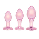Scale Reference: Three pink-tinted glass gem plugs grouped together to illustrate Small, Medium, and Large sizes.