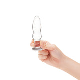 A hand holding the 4.25-inch plug to show the manageable size and the placement of the center bead.