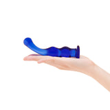 Blue glass dildo in a hand on a white background