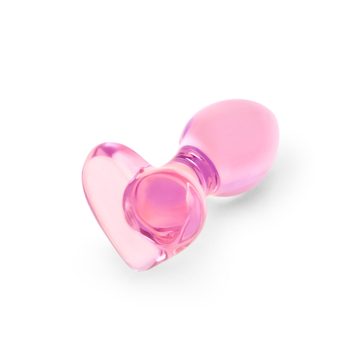 Pink heart-shaped glass anal plug on a white background
