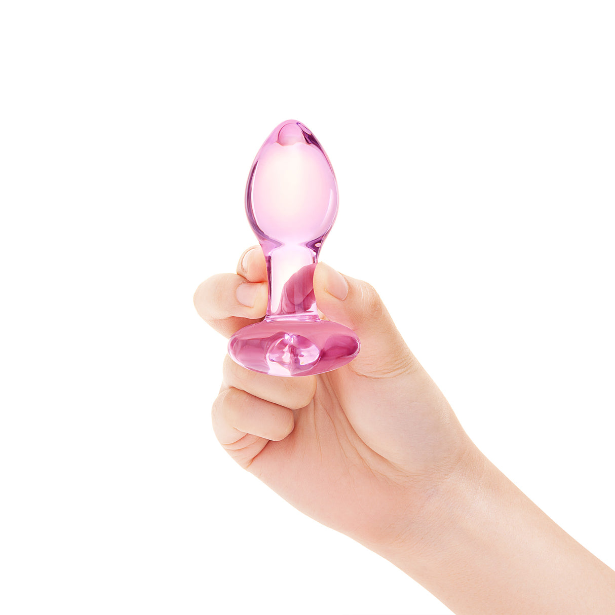 Hand holding a pink  Heart Base Glass Toy  product against a white background