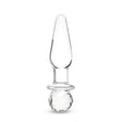 Glass anal plug with round base on a white background