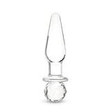 Glass anal plug with round base on a white background