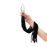 Hand holding a Glass Plug with Flogger  on a white background