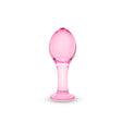 Pink glass anal plug on a white background