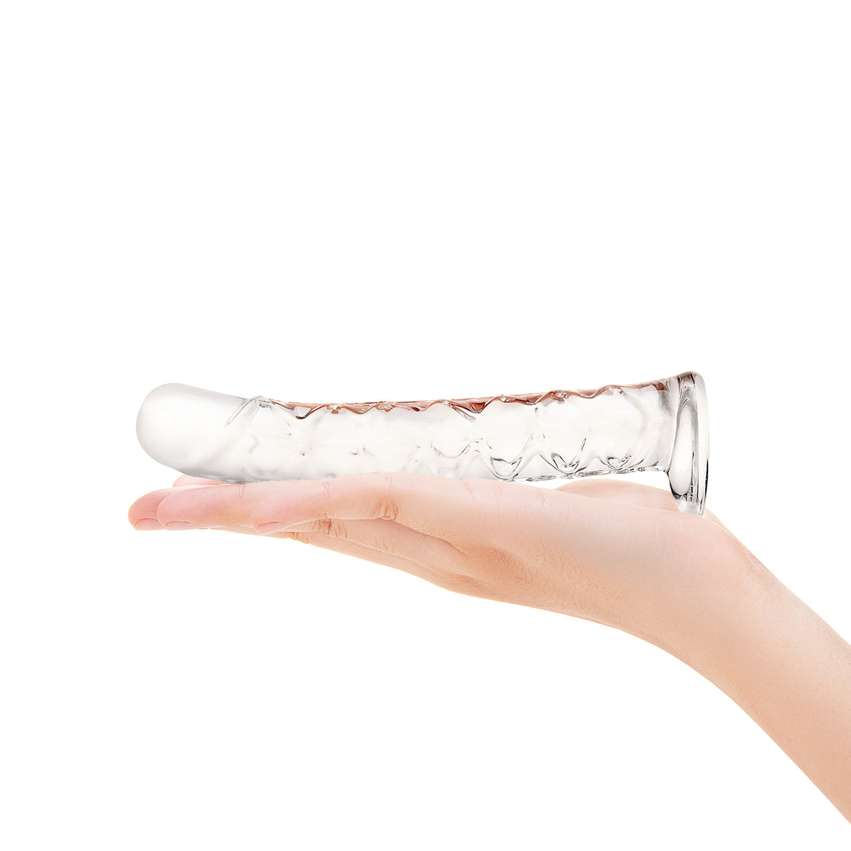 Clear Textured Glass Dildo held in a hand against a white background