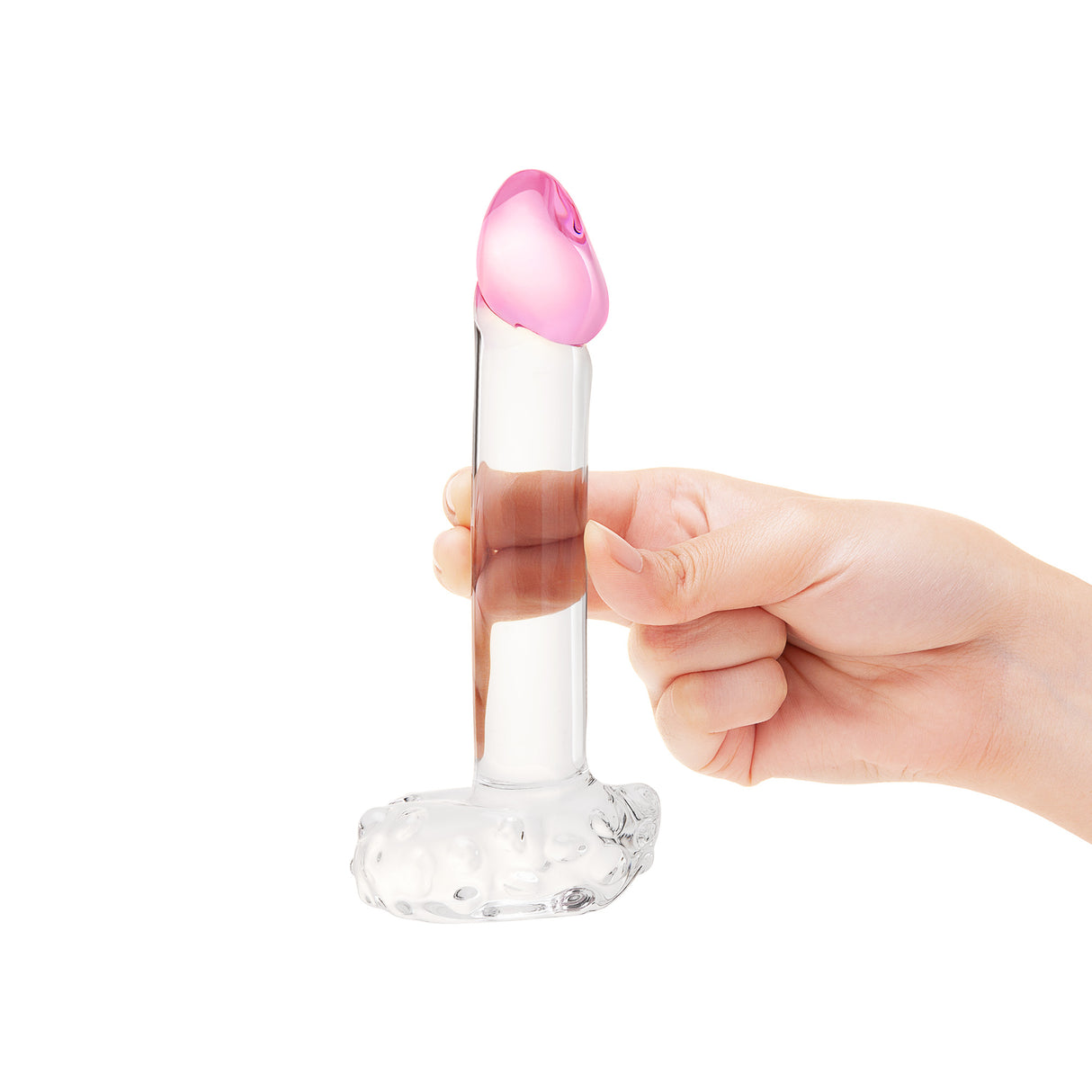 Hand holding a Realistic Glass Dildo with Textured Base,  Smooth Base and Pink Tip against a white background