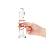Textured Curved Glass Dildo with a realistic tip and a spiral design held by a hand on a white background