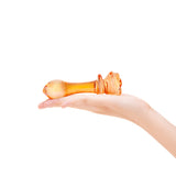Orange teardrop shaped tip with rosebud base butt plug  on a white background
