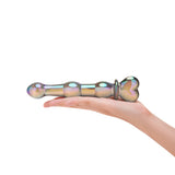 Glass dildo with an Iridescent Beaded Shaft and a heart base on a white background