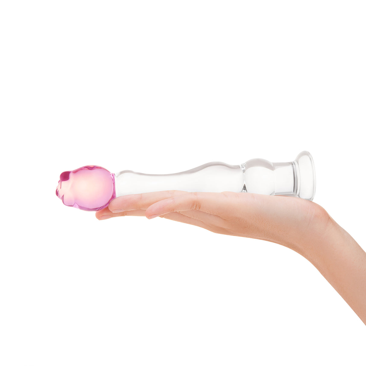 textured glass dildo, featuring gentle ripples, a tapered tip, and a secure pink rosebud base held in a hand on a white background