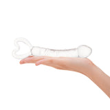 Spiraled Ridge Glass Dildo with heart-shaped base held in a hand on a white background