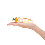 Hand holding a Glass anal plug featuring a rippled shaft and a jack-o-lantern pumpkin-shaped base on a white background