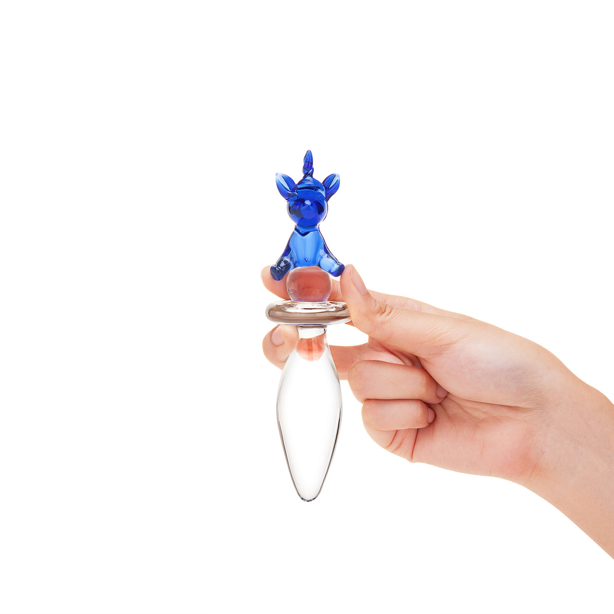 Hand holding a cUnicorn Handle Glass Plug on a white background