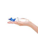 Hand holding a Unicorn Handle Glass Plug  on a white background