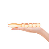 Hand holding a Dual-Ended Beaded Glass Dildo - smooth tapered end and a beaded shaft on a white background