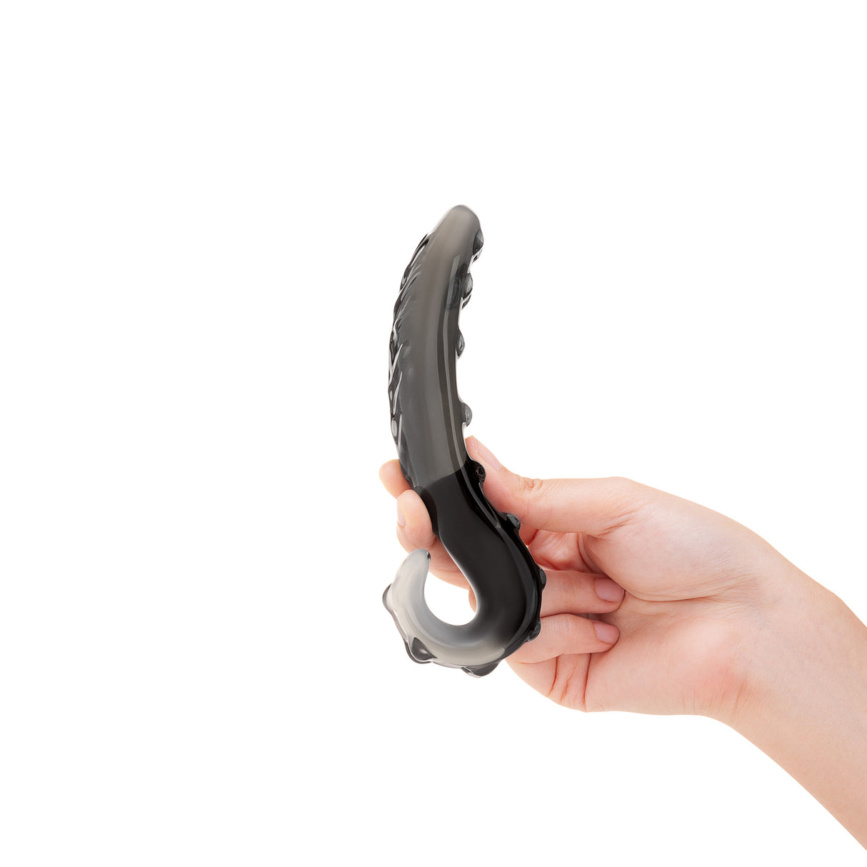 Hand holding a  Black Nubbed G-Spot Glass Dildo against a white background
