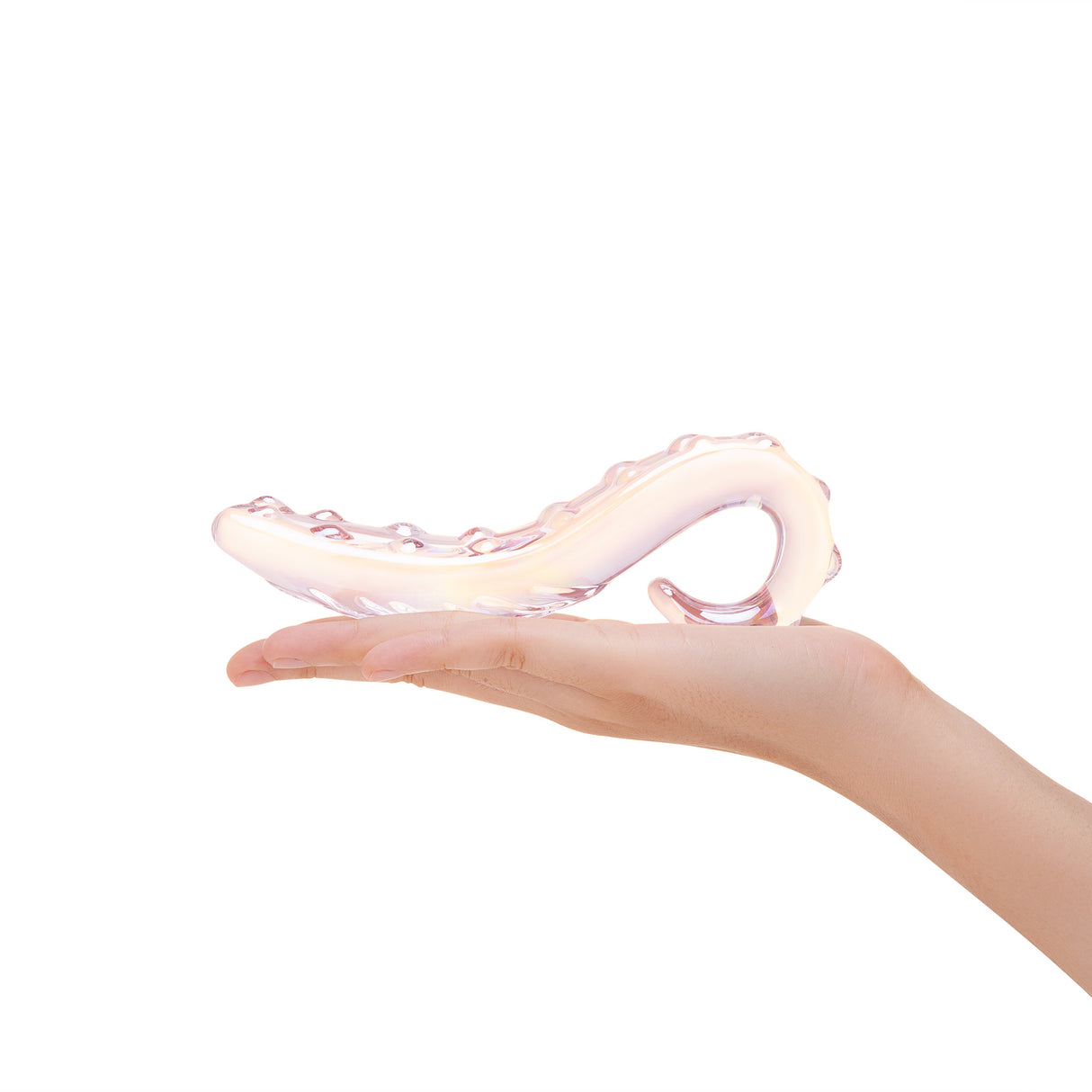 Hand holding a Nubbed glass dildo with tapered tip and ridges on a white background