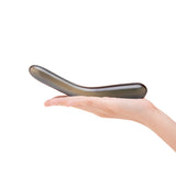 Hand holding a Black Curved Dual-Ended Glass Dildo against a white background