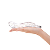 Glow in the Dark Curved Glass Dildo with teardrop tip and ring-shaped handle on a hand against a white background