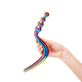 Hand holding a Multicolored Dual-Ended Glass Dildo with beaded and smooth ends against a white background