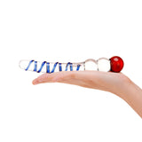 Hand holding a Dual-Ended Glass Dildo featuring a swirled textured shaft and beaded tip with blue and red colors on a white background