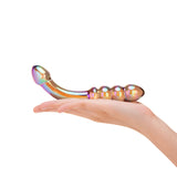 Hand holding a cMulticolored Dual-Ended Glass Dildo with beaded and bulb tip  against a white background